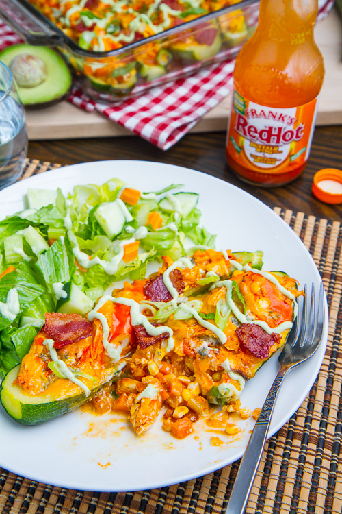 Buffalo Chicken Stuffed Zucchini topped with Melted Cheddar, Bacon and an Avocado Blue Cheese Dressing Buffalo Chicken Stuffed Zucchini topped with Melted Cheddar, Bacon and an Avocado Blue Cheese Dressing